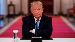 US President Donald Trump sits with his arms crossed during a roundtable discussion on the Safe Reopening of Americas Schools during the coronavirus pandemic, in the East Room of the White House on July 7, 2020, in Washington, DC.