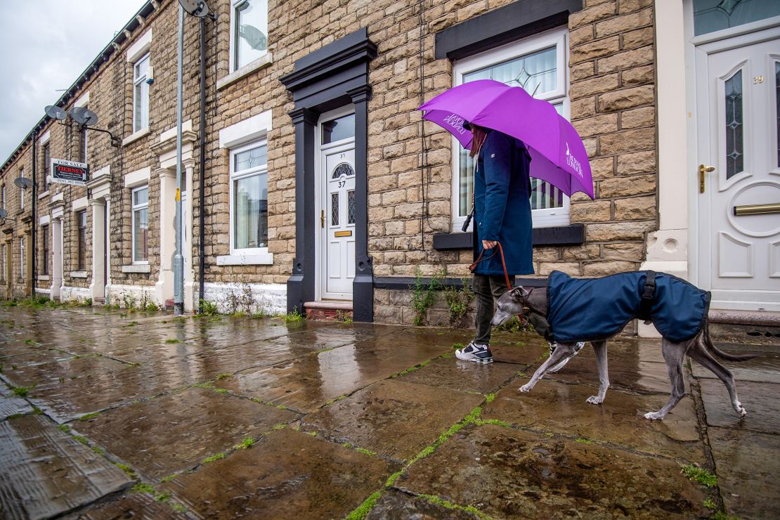 A pedestrian walks a dog along a street in Manchester on July 7.