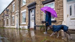 A pedestrian walks a dog along a stone paved street in Stalybridge, Greater Manchester, U.K., on Tuesday, July 7, 2020. U.K. Chancellor of the Exchequer Rishi Sunak is likely to continue a policy of boosting demand for housing rather than increasing supply when he presents his economic recovery plan on Wednesday. Photographer: Anthony Devlin/Bloomberg via Getty Images