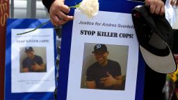 Mourners hold images of Andres Guardado, 18, who was fatally shot by a Los Angeles County sheriff's deputy, at a memorial site in Gardena, Calif., Friday, June 19, 2020. 