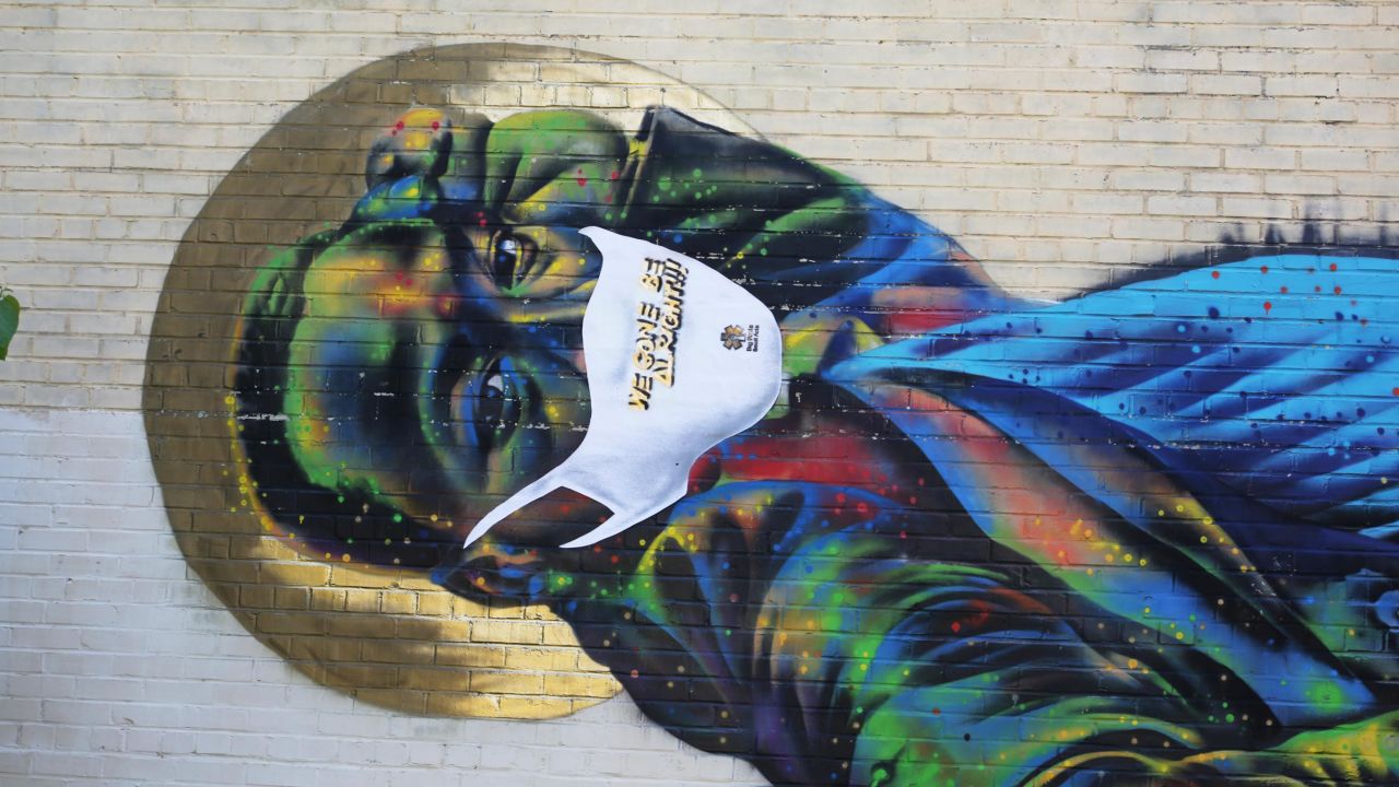 A street mural of Martin Luther King Jr. by Atlanta-based artist Fabian Williams is covered with a vinyl mask as part of the Covid-19 public awareness campaign Big Facts Small Acts. 