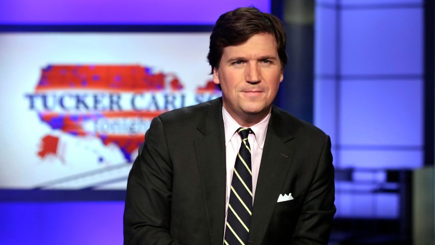 FILE - In this March 2, 2017 file photo, Tucker Carlson, host of "Tucker Carlson Tonight," poses for photos in a Fox News Channel studio, in New York.  Carlson has advocated restraint in dealing with Iran, and resisted cheerleading the Trump-ordered drone killing of Iranian Gen. Qasem Soleimani. (AP Photo/Richard Drew, File)