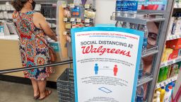 Florida, Miami Beach, Walgreens pharmacy, Social distancing at check out counter, with shopper and cashier both wearing PPE, face masks and gloves. (Photo by Jeff Greenberg/Universal Images Group/Getty Images)