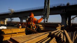 A contractor guides wooden boards during construction on the San Joaquin River viaduct section of a high-speed rail project in Madera, California, U.S., on Thursday, Feb. 13, 2020. The estimated cost of the controversial project has grown to $80.3 billion, an increase from the $79 billion projected last year. Photographer: Patrick Fallon/Bloomberg via Getty Images