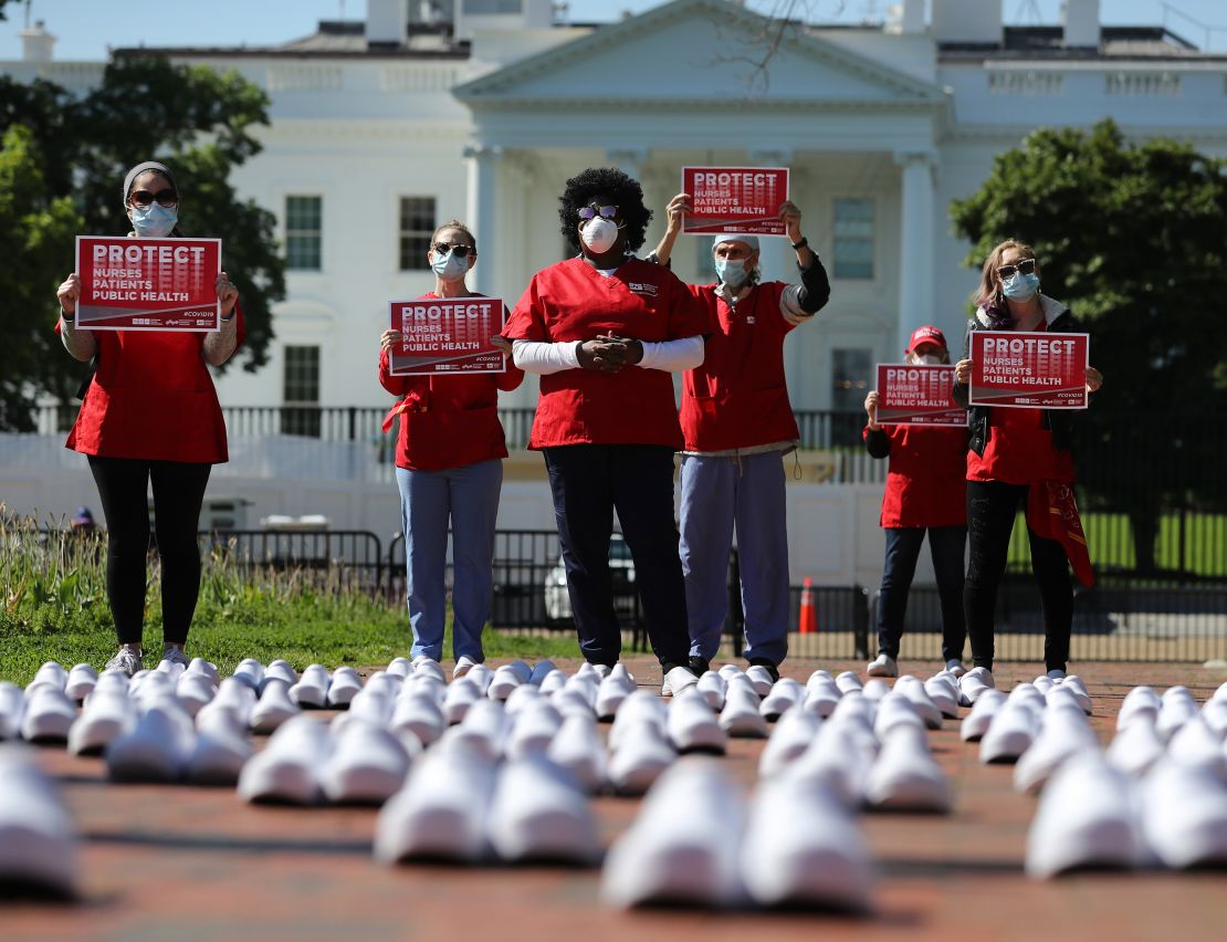 Members of the National Nurses United stand in protest among empty shoes representing nurses that they say have died from Covid-19 in Lafayette Park across from the White House May 07, 2020, in Washington, DC. 