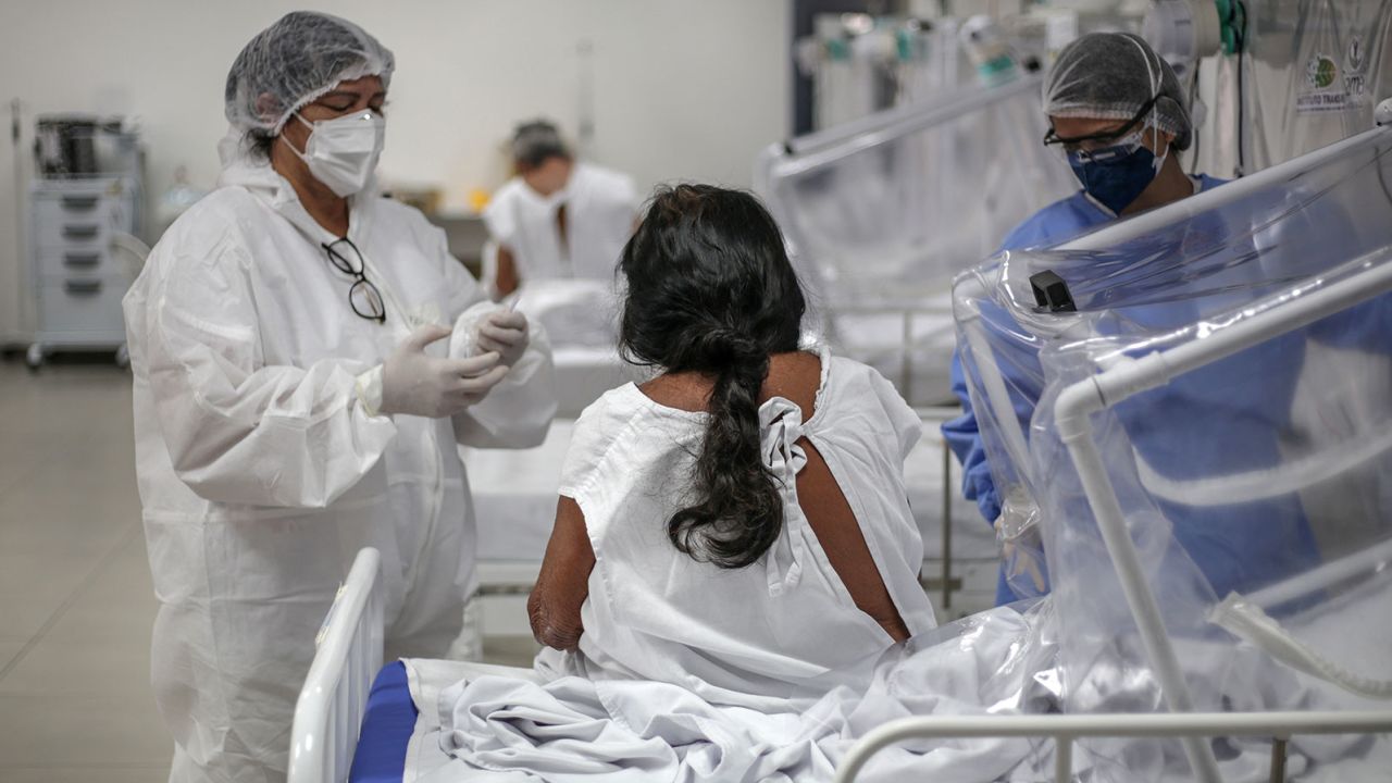 MANAUS, BRAZIL - MAY 27: Nurses check Nazaria Lopes, 92, a Baniwa people indigenous woman, infected by coronavirus (COVID-19) at the Gilberto Novaes Municipal Field Hospital on May 27, 2020 in Manaus, Brazil. The hospital has two new wards exclusively dedicated to indigenous people. (Photo by Andre Coelho/Getty Images)