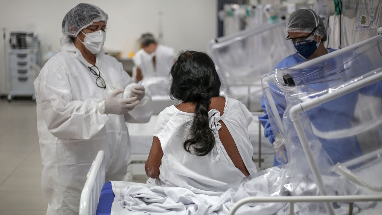 Nurses check Nazaria Lopes, a Baniwa people indigenous woman, infected by coronavirus at the Gilberto Novaes Municipal Field Hospital on May 27