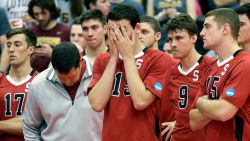 FILE - In this May 3, 2014, file photo, Stanford men's volleyball head coach John Kosty, second from left, looks down as players react after a 3-1 loss to Loyola in the NCAA men's college volleyball championship at Gentile Arena in Chicago. Stanford announced Wednesday, July 8, 2020,  that it is dropping 11 sports amid financial difficulties caused by the coronavirus pandemic. The school will discontinue men's and women's fencing, field hockey, lightweight rowing, men's rowing, co-ed and women's sailing, squash, synchronized swimming, men's volleyball and wrestling after the 2020-21 academic year. Stanford also is eliminating 20 support staff positions. (AP Photo/Nam Y. Huh, File)