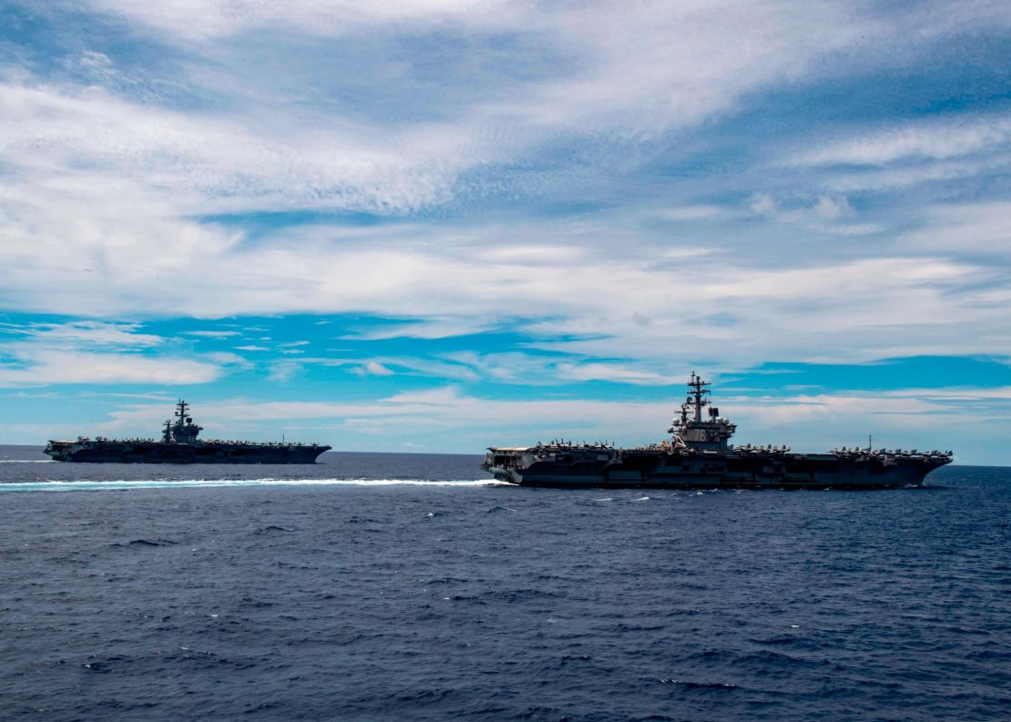 The Nimitz-class aircraft carriers USS Nimitz and Ronald Reagan transit the South China Sea.