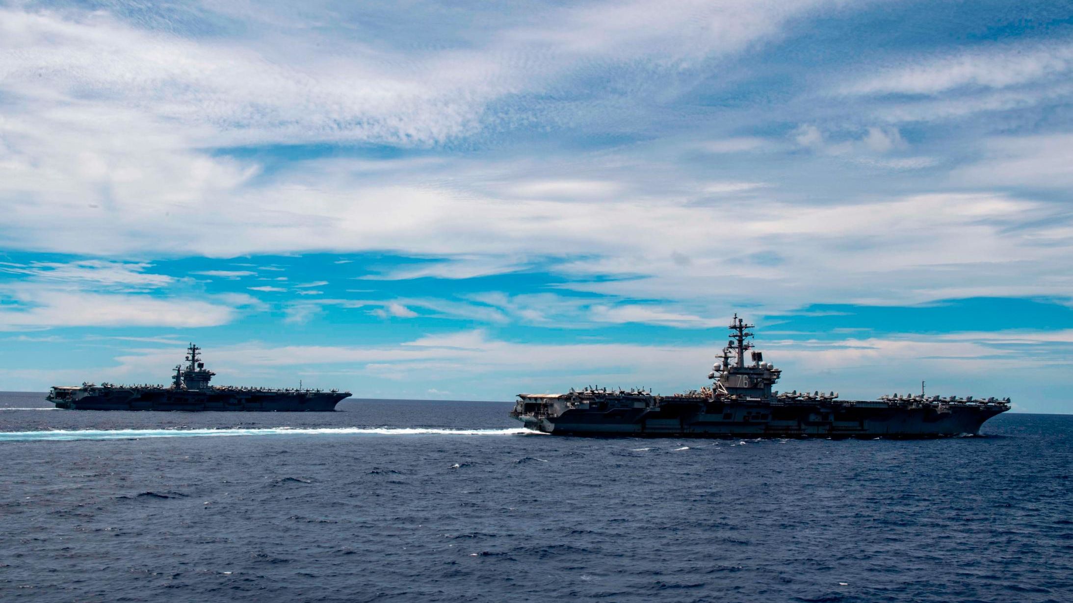 The Nimitz-class aircraft carriers USS Nimitz and Ronald Reagan transit the South China Sea.