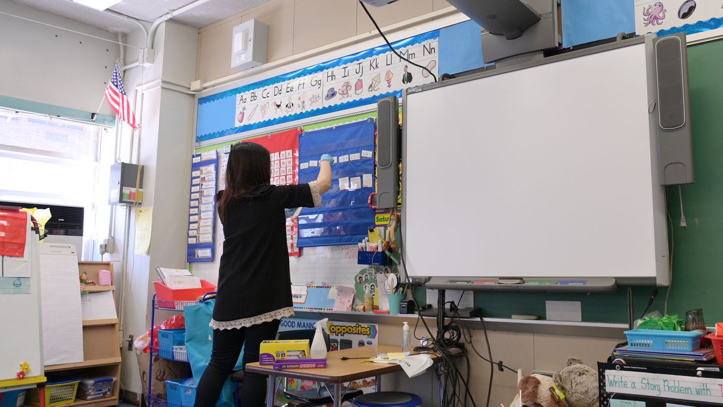 A teacher collects supplies needed to continue remote teaching through the end of the school year at Yung Wing School P.S. 124 on May 14, 2020 in New York City.