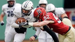 Yale quarterback Griffin O'Connor, left, tries to elude Harvard linebacker Cameron Kline (52) while scrambling for a gain during the first half of an NCAA college football game at Fenway Park in Boston, Saturday, Nov. 17, 2018. 