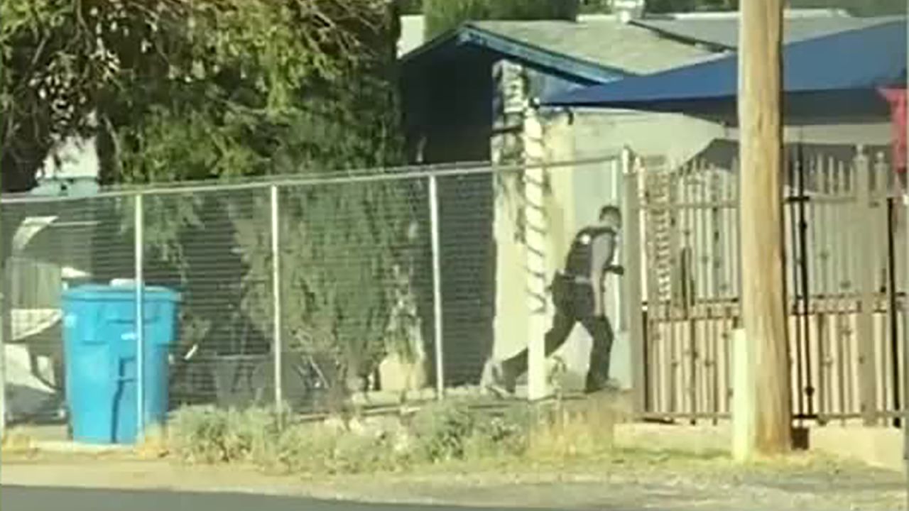 Police officer Joshua Gonzalez running toward the mobile home in Socorro.