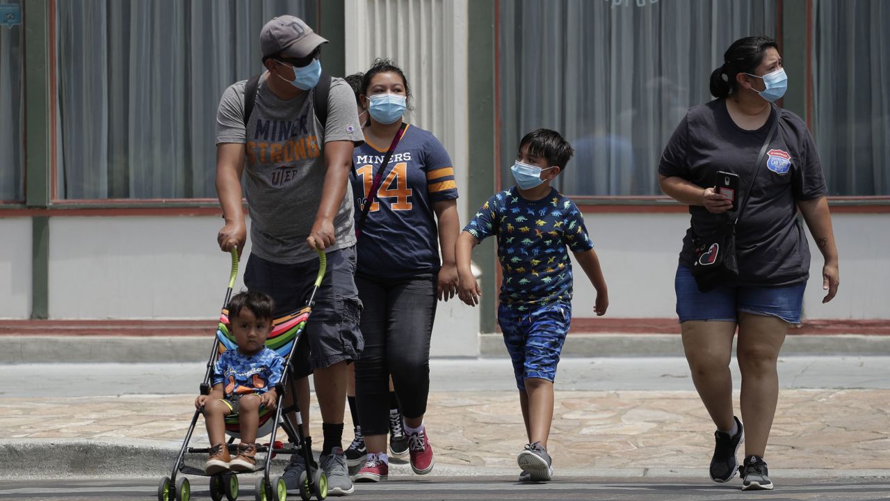 Visitors wearing masks to protect against the spread of COVID-19, walk through downtown San Antonio, Texas, on Wednesday, June 24, 2020. Cases of COVID-19 have spiked in Texas and the governor of Texas is encouraging people to wear masks in public and stay home if possible. (AP Photo/Eric Gay)