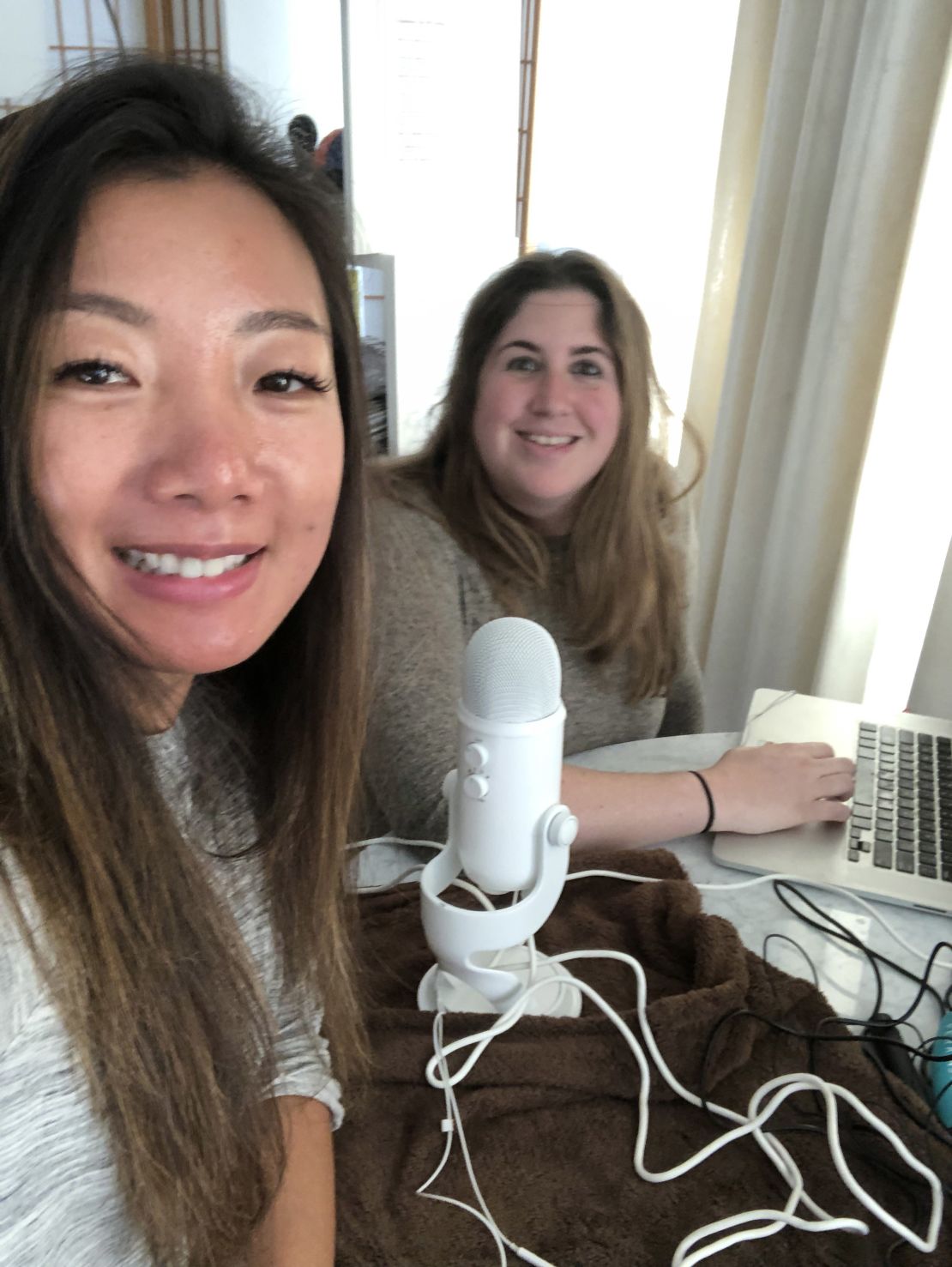 Yue Xu and Julie Krafchick take a selfie while hosting their podcast.