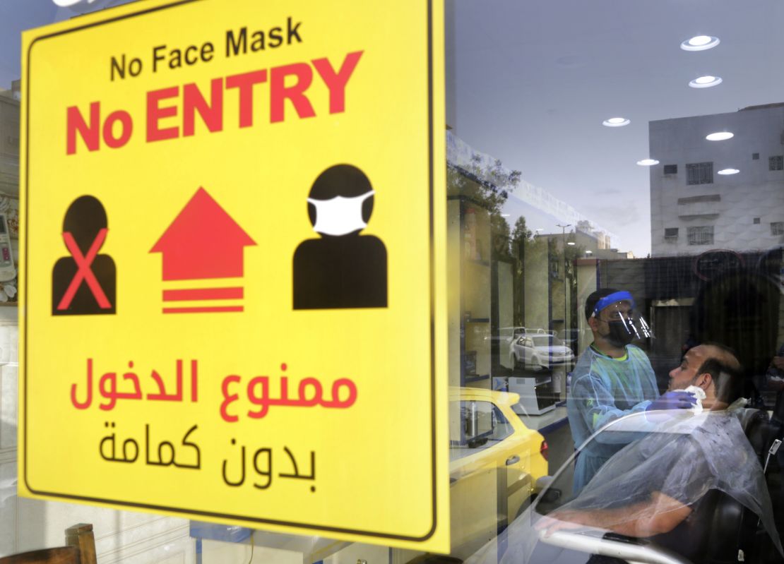 A health information poster hangs at a barber shop window in Jiddah, Saudi Arabia, on June 28.