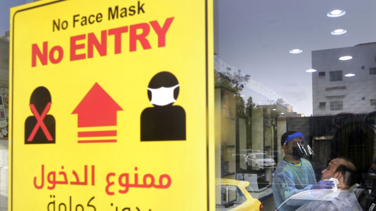 A health information poster hangs at a barber shop window in Jiddah, Saudi Arabia, on June 28.