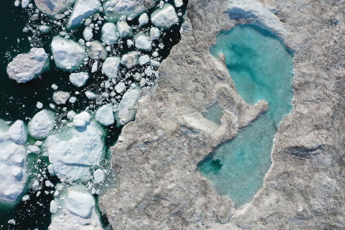ILULISSAT, GREENLAND - In this aerial view melting ice forms a lake on free-floating ice jammed into the Ilulissat Icefjord during unseasonably warm weather on July 30, 2019 near Ilulissat, Greenland. 