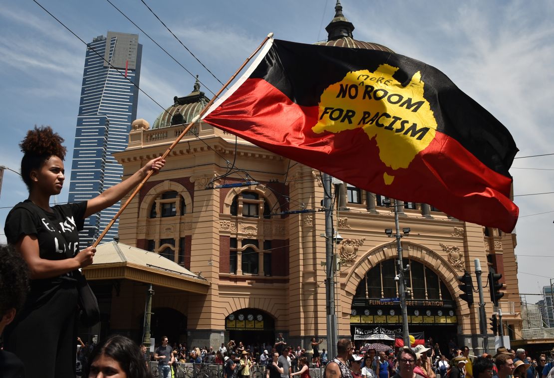 A woman waves the Aboriginal flag on January 26, 2018, during a rally to mark what many Indigeous Australians call "Invasion Day."