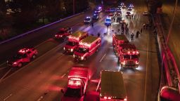 Emergency personnel work at the site where a driver sped through a protest-related closure on the Interstate 5 freeway in Seattle, authorities said.