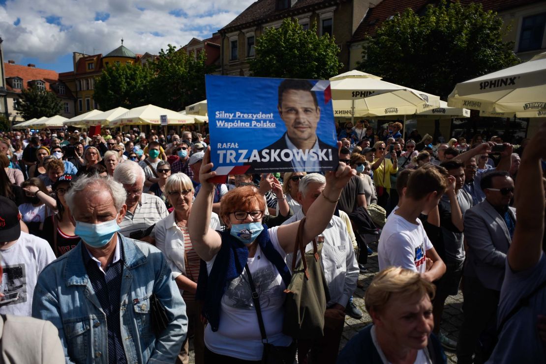 A supporter of Rafal Trzaskowski holds a banner as the Warsaw Mayor delivers a speech during a campaign rally on July 7 in Gniezno, Poland.
