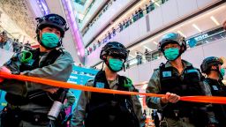 Riot police stand guard during a clearance operation during a demonstration in a mall in Hong Kong on July 6, 2020, in response to a new national security law introduced in the city which makes political views, slogans and signs advocating Hong Kongs independence or liberation illegal. - Hong Kongers are finding creative ways to voice dissent after Beijing blanketed the city in a new security law and police began making arrests for people displaying now forbidden political slogans. (Photo by ISAAC LAWRENCE / AFP) (Photo by ISAAC LAWRENCE/AFP via Getty Images)