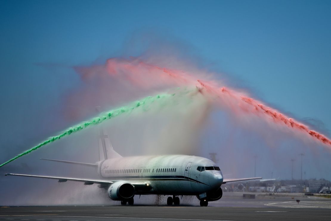 Firefighters spray water in Portugal's national colors as the team return from France.