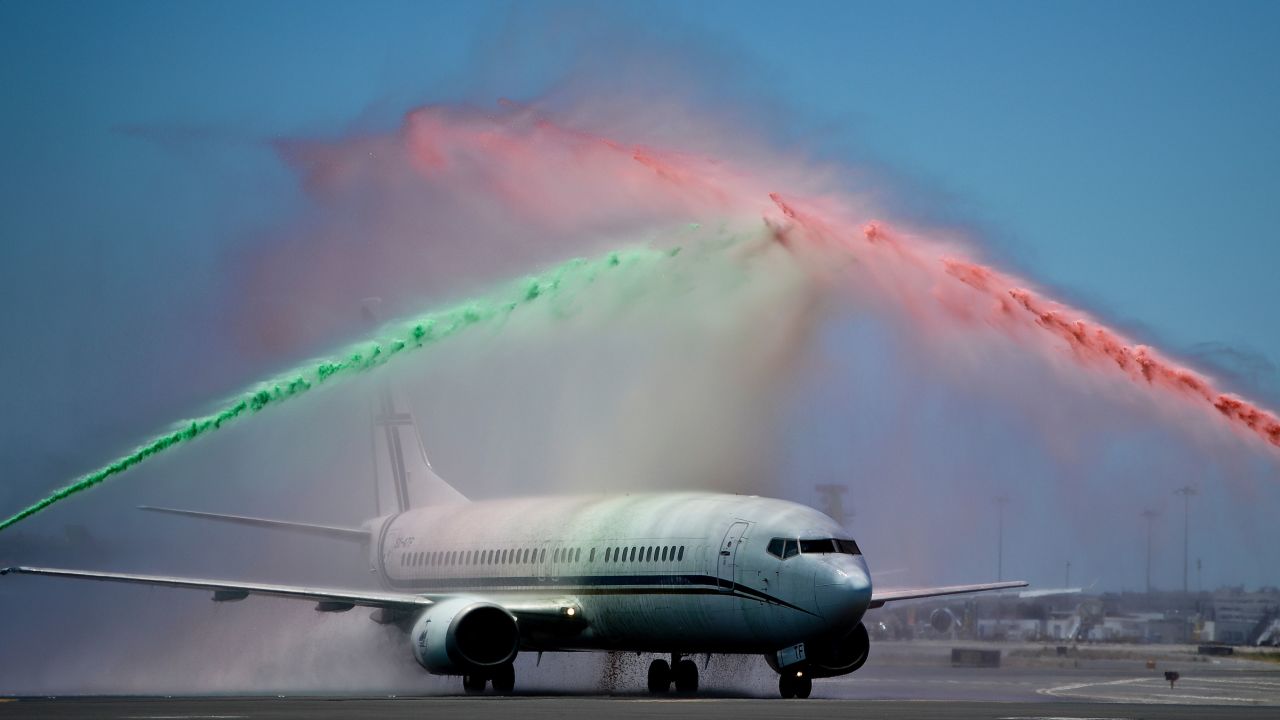 Firefighters spray water in Portugal's national colors as the team return from France.