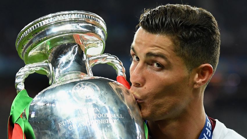 PARIS, FRANCE - JULY 10:  Cristiano Ronaldo of Portugal kisses the Henri Delaunay trophy to celebrate after their 1-0 win against France in the UEFA EURO 2016 Final match between Portugal and France at Stade de France on July 10, 2016 in Paris, France.  (Photo by Matthias Hangst/Getty Images)