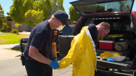 El Centro Fire Department Captain Chad Whitlock is helped out of his protective gear after helping a patient.