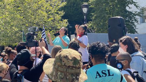 Melina Abdullah, co-founder of Black Lives Matter Los Angeles, seen in a white shirt, leads a protest in front of Lacey's office on July 1.