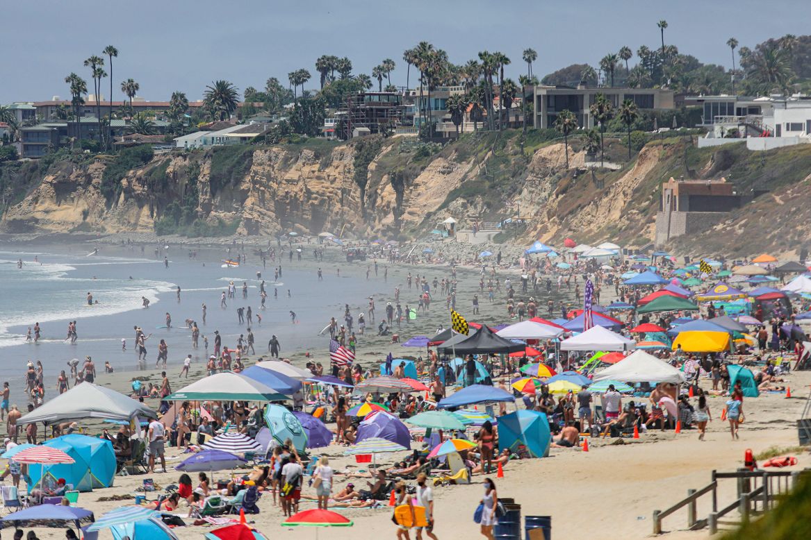People pack a beach in San Diego on Saturday, July 4. Because of a surge in coronavirus cases, many other California beaches were shut down for the Fourth of July weekend.