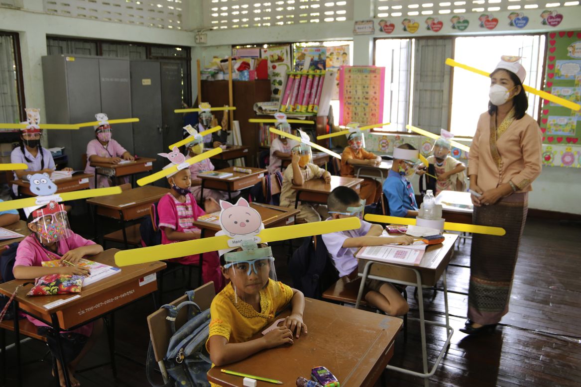 Schoolchildren wear special hats to help them practice social distancing in Chiang Mai, Thailand, on Friday, July 3.