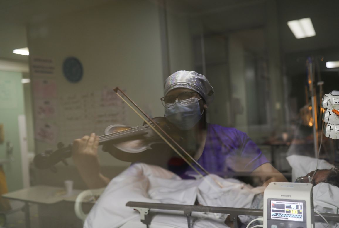 Nurse Damaris Silva plays the violin for coronavirus patients inside a Santiago, Chile, hospital on Thursday, July 2.