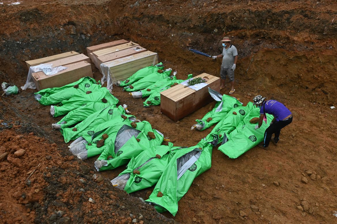 Bodies are placed in a mass grave on Saturday, July 4, after at least 162 people were killed in a <a href="https://www.cnn.com/2020/07/02/asia/myanmar-jade-mine-landslide-intl-hnk/index.html" target="_blank">landslide at a jade mine</a> in northern Myanmar. Others were injured or feared to be trapped.