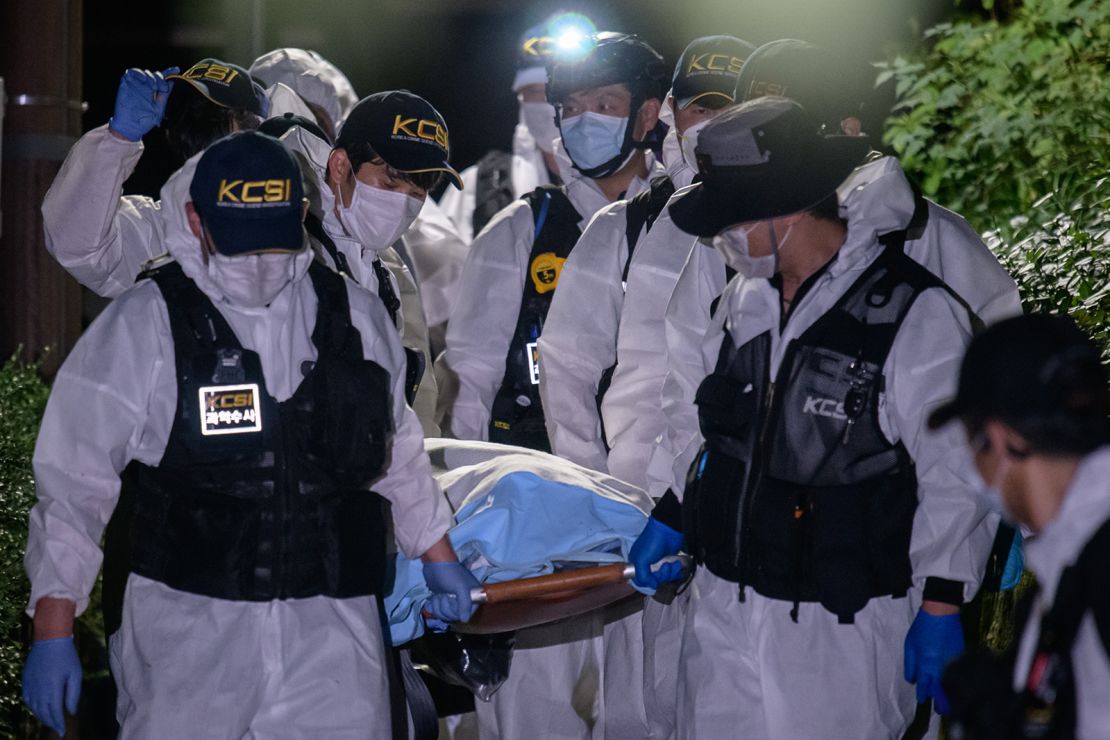 A forensic team carries the body of Park Won-soon on July 10, 2020. 