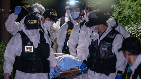 A forensic team carries the body of Park Won-soon on July 10, 2020. 