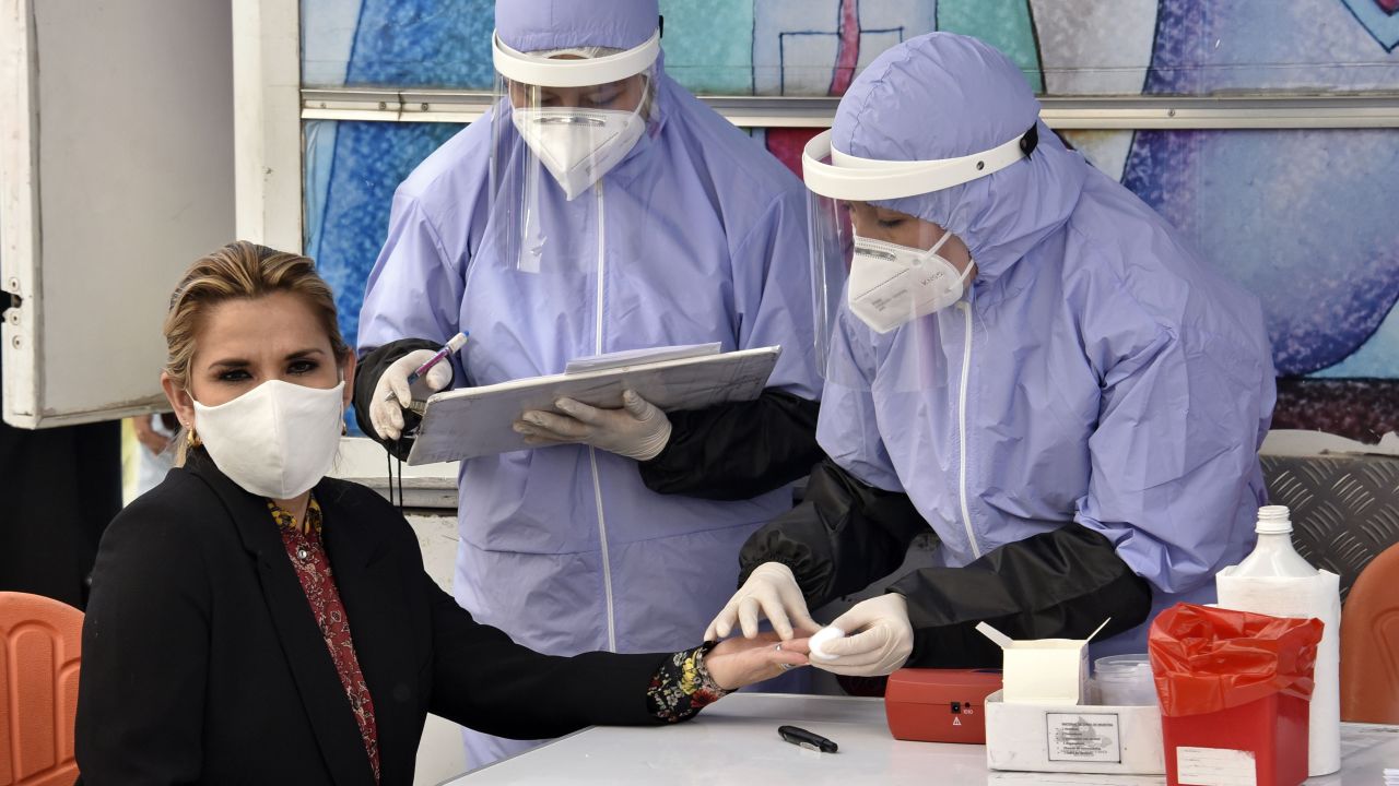 Bolivian President Jeanine Anez (L) takes a blood test before donating blood on Blood Donor Day, at the presidential palace in La Paz on June 12, 2020 amid the COVID-19 novel coronavirus pandemic. - Anez exhorted the population to donate blood, especially those who recovered from COVID-19. (Photo by Aizar RALDES / AFP) (Photo by AIZAR RALDES/AFP via Getty Images)