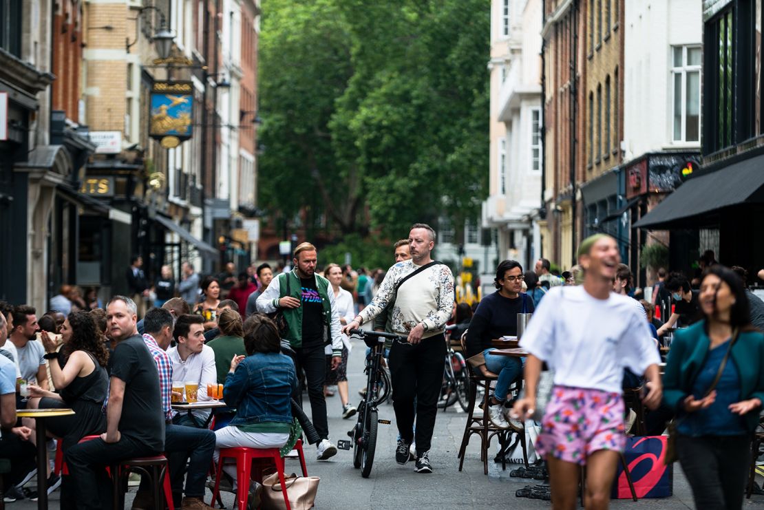 Customers enjoy their drinks in Soho, London, earlier in July as pubs, restaurants, hotels and hairdressers in England reopen.