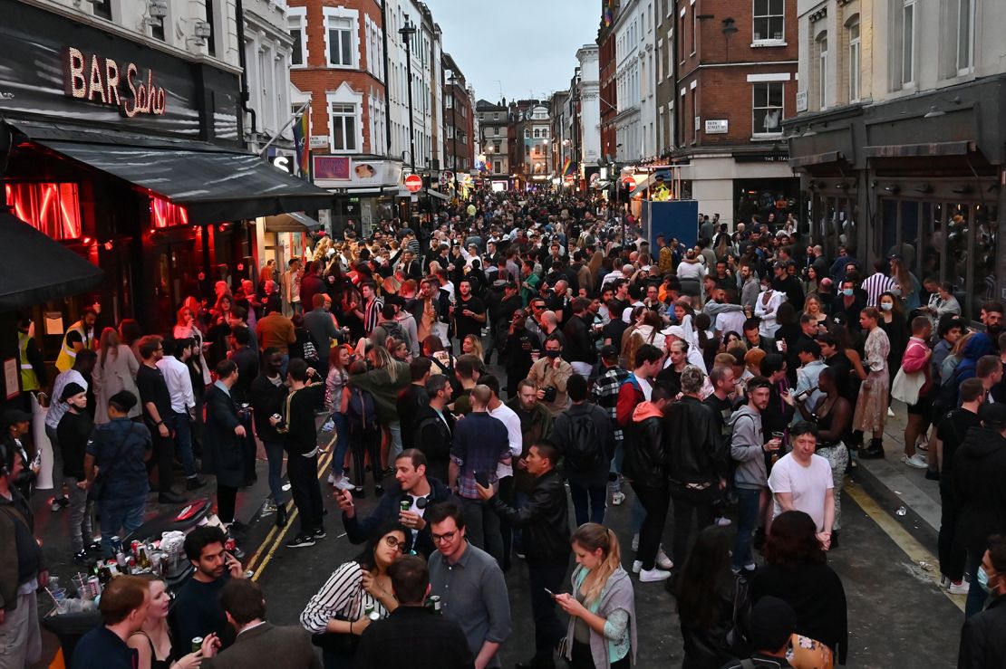 Revellers pack a street outside bars in the Soho area of London on July 4, as restrictions are further eased.