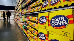 In this April 29, 2015, file photo, people walk past displays of Goya Foods products at the new corporate headquarters in Jersey City, N.J. Goya Foods is facing a a swift backlash after its CEO Robert Unanue praised President Donald Trump at White House event on Thursday, July 9, 2020. Almost immediately, Twitter exploded, with users both famous and not reminding Unanue of Trump's history of derogatory comments and harsh policies toward Hispanics, most notably, the administration's policy of separating immigrant families at the U.S.-Mexico border. (AP Photo/Mel Evans, File)