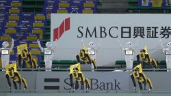 SoftBank Corp's humanoid robots Pepper (white) and Boston Dynamics' robots SPOT (yellow) dance and sing before the Nippon Professional Baseball league match between SoftBank Hawks and Rakuten Golden Eagles in Fukuoka on July 10, 2020. (Photo by STR / JIJI PRESS / AFP) / Japan OUT (Photo by STR/JIJI PRESS/AFP via Getty Images)