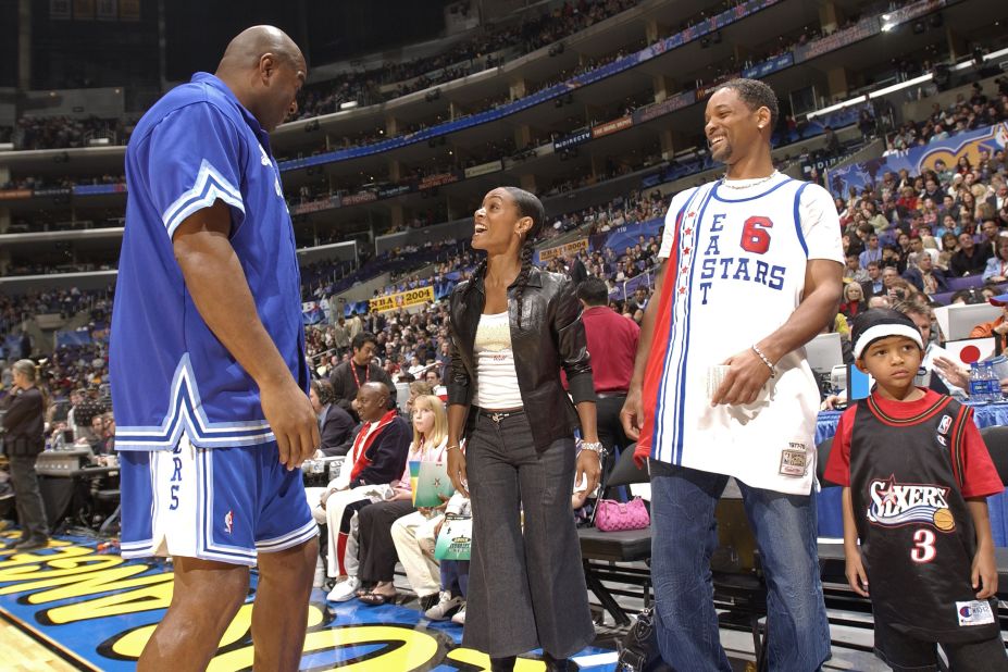 Basketball legend Magic Johnson talks to Will and Jada at an NBA All-Star event in February 2004.