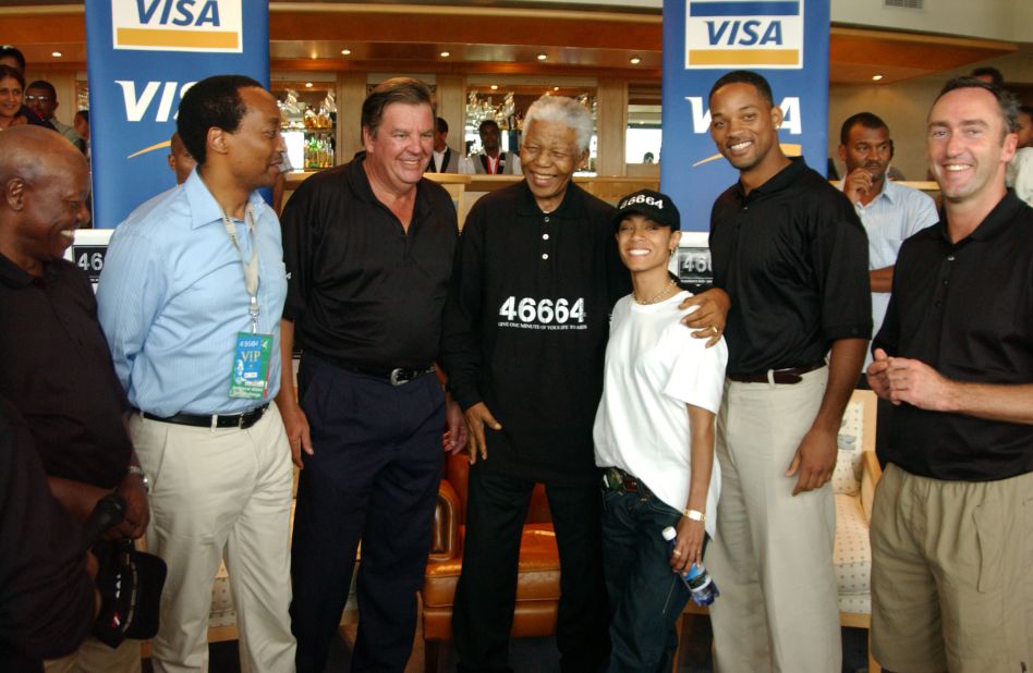 Former South African President Nelson Mandela puts his arm around Jada at a charity golf tournament in March 2005.