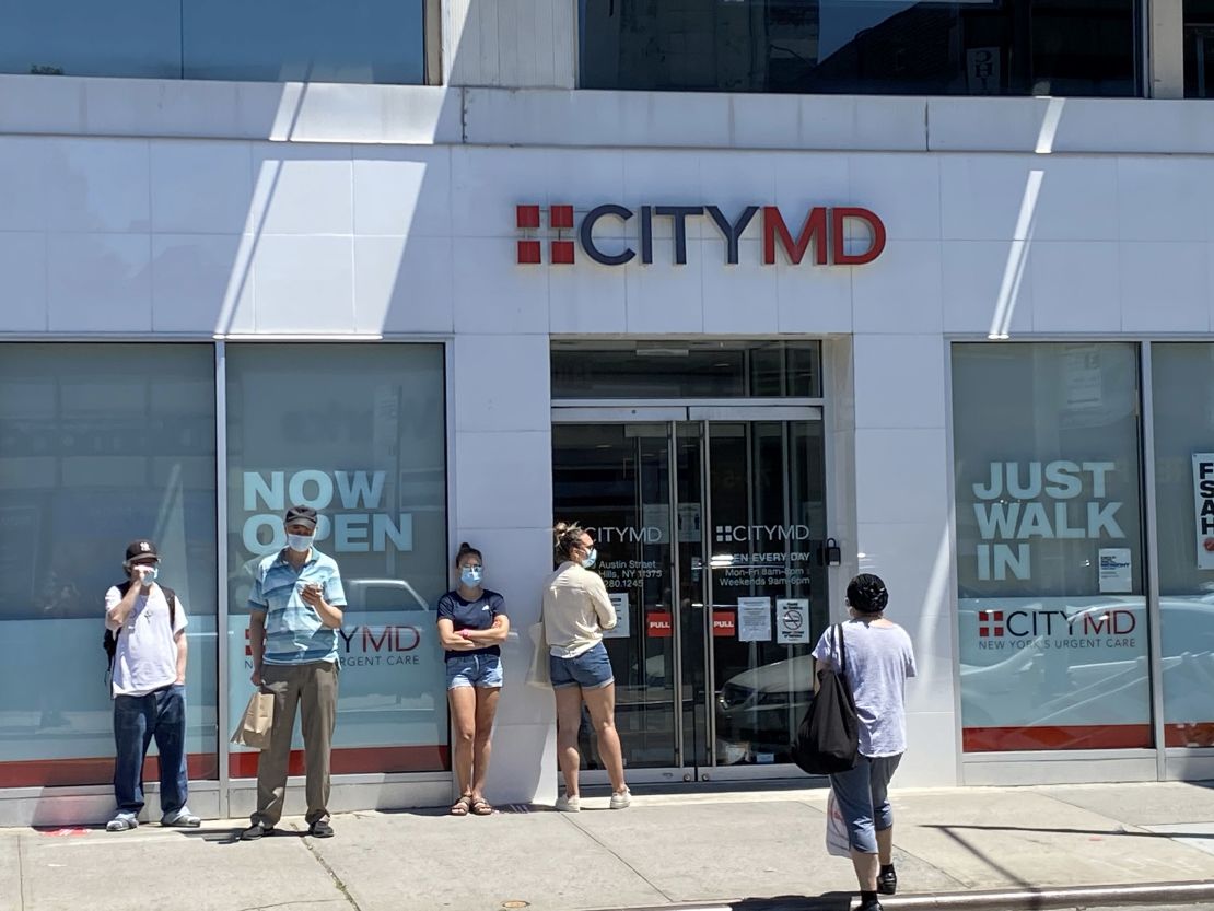 People form a line outside of the CityMD clinic in Forest Hills, Queens, New York.