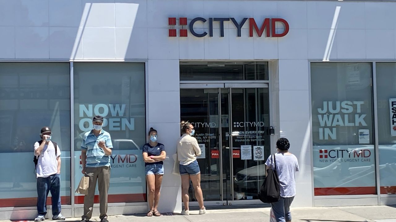 People form a line outside of the CityMD clinic in Forest Hills, Queens, New York.