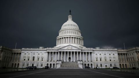 Storm clouds fill the sky over the US Capitol Building.