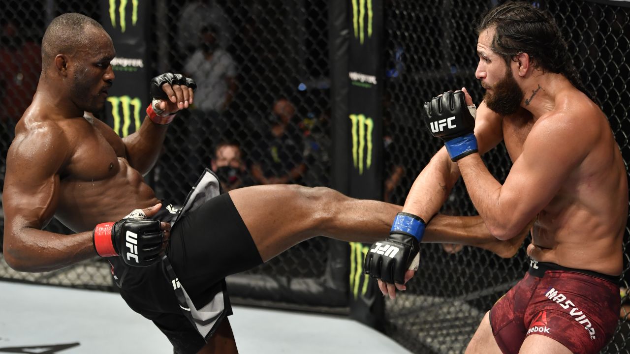 Kamaru Usman, left, kicks Jorge Masvidal in their title bout at UFC 251.