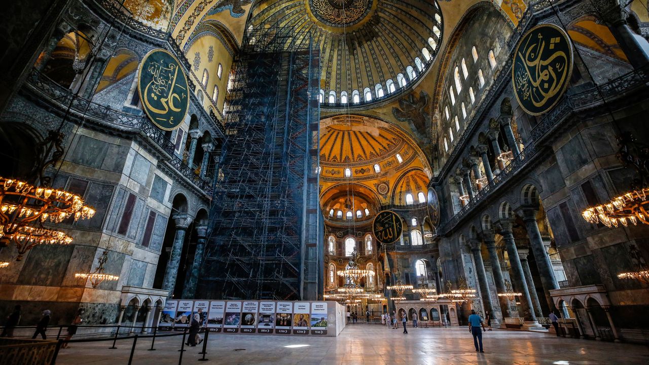 People visit the Byzantine-era Hagia Sophia, one of Istanbul's main tourist attractions in the historic Sultanahmet district of Istanbul on Thursday, June 25, 2020. The 6th-century building is now at the center of a heated debate between conservative groups who want it to be reconverted into a mosque and those who believe the World Heritage site should remain a museum. (AP Photo/Emrah Gurel)