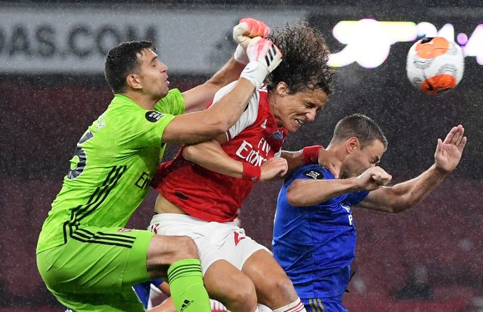 From left, Arsenal's Emiliano Martinez and David Luiz compete for a loose ball with Leicester City's Jonny Evans during a match between Arsenal and Leicester City in London on July 7.
